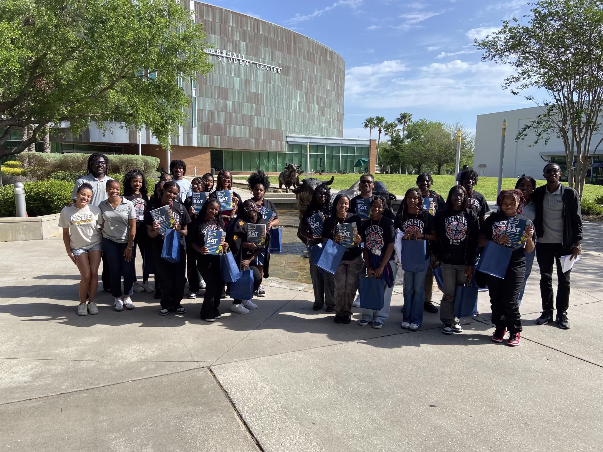 USF NSBE members distributing SAT prep books to underserved communities